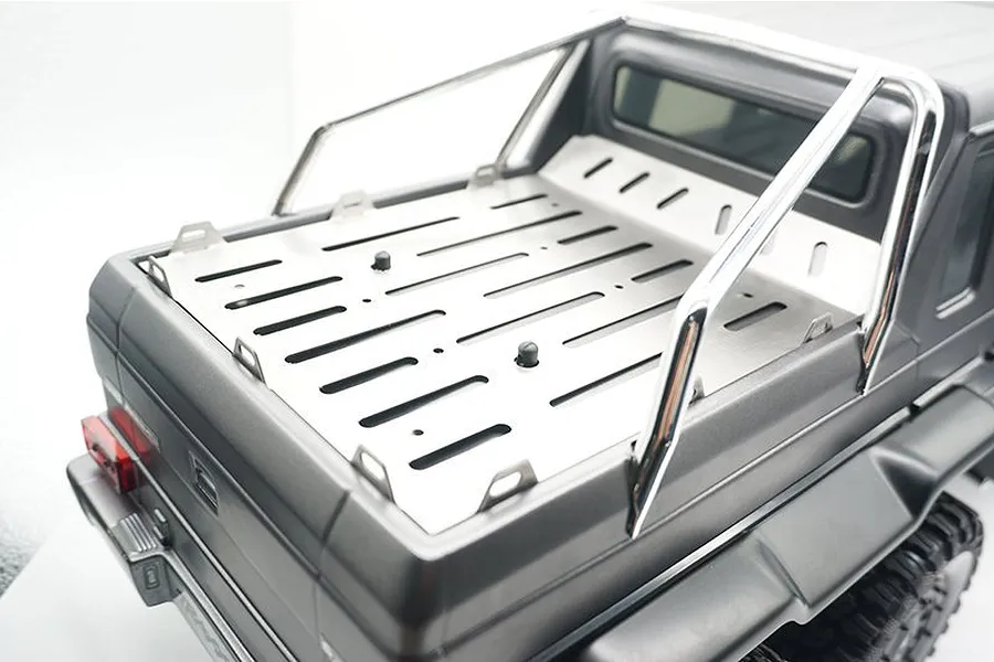 A stainless steel tray cover installed on the rear bed of a black Traxxas TRX-6 Mercedes-Benz G 63 AMG RC crawler.