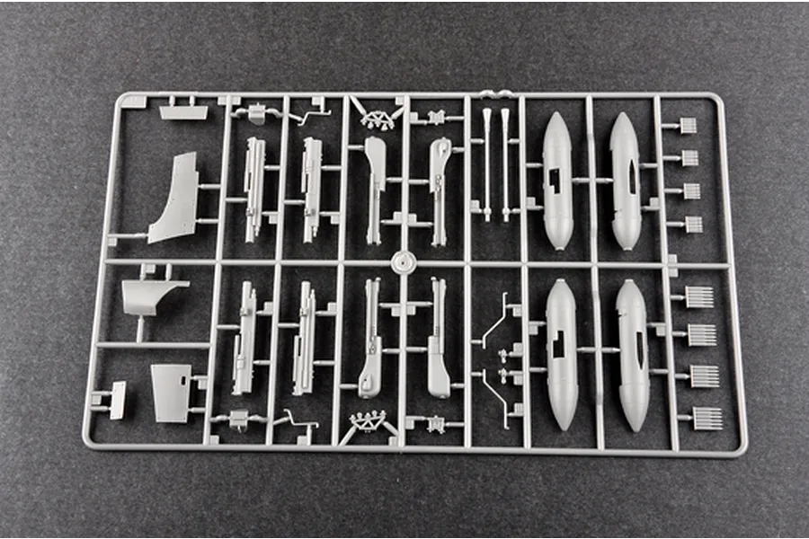 A grey plastic sprue from a Trumpeter 1/32 scale model kit containing various aircraft parts including fuselage sections and small components.