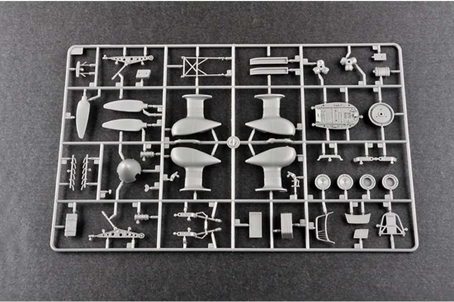 A grey plastic sprue containing various model aircraft parts for a Trumpeter 1/32 Junkers Ju-87D Stuka kit, laid out on a dark grey surface.