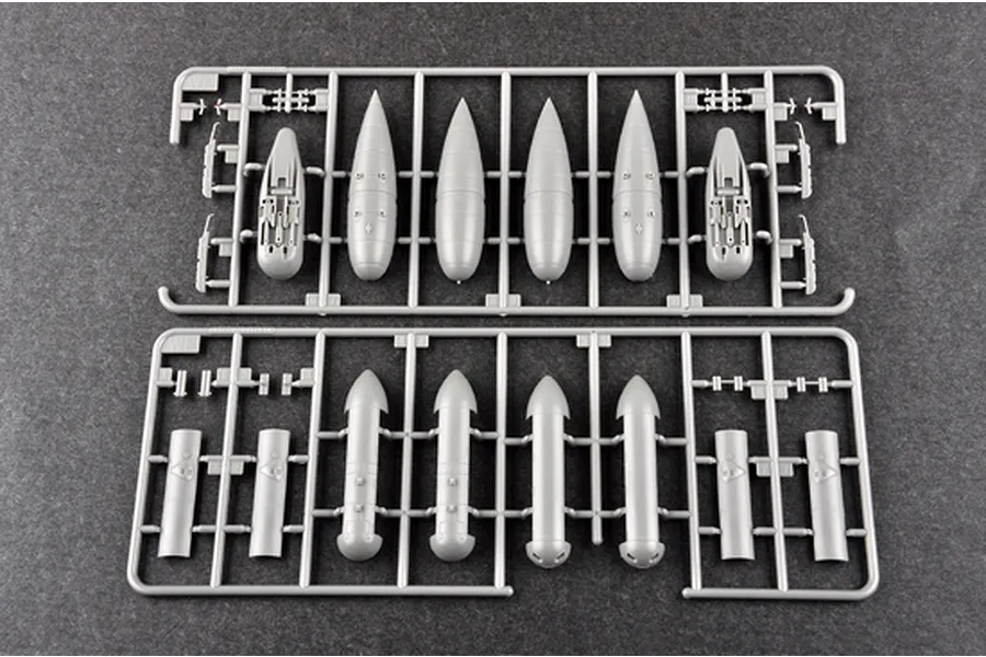 Two grey plastic model kit sprues containing various bomb and fuselage components for a 1/32 scale aircraft model.