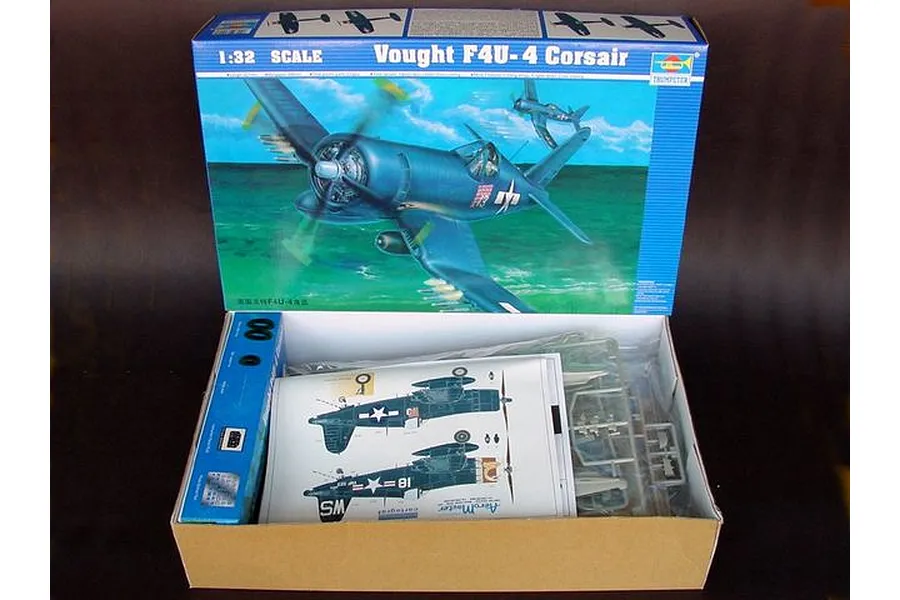 Open box of Trumpeter 1/32 scale Vought F4U-4 Corsair plastic model kit showing instruction manual, decals, and plastic parts trees.