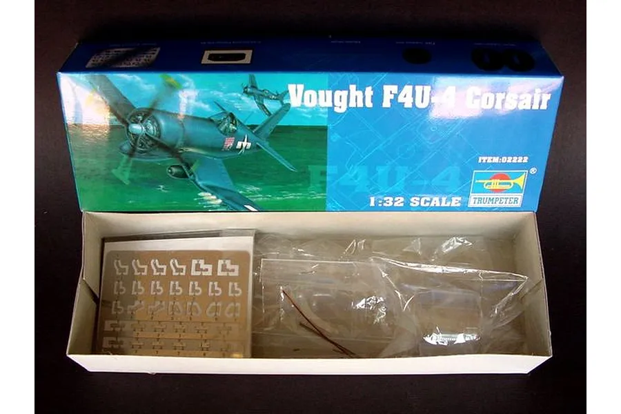 Open box of the Trumpeter 1/32 scale Vought F4U-4 Corsair plastic model kit showing box art and internal parts in plastic bags.