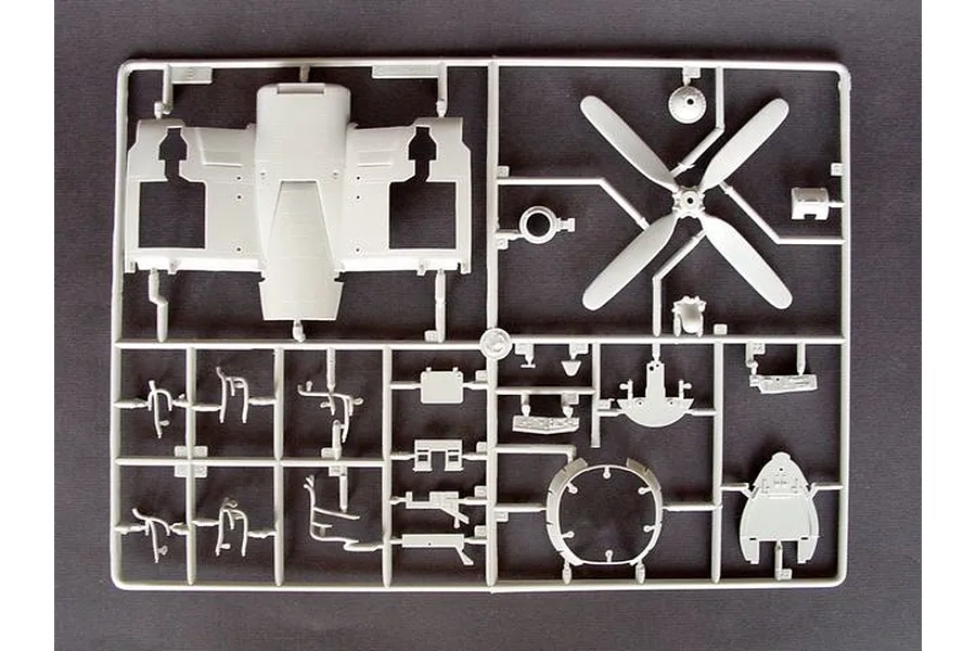 A grey plastic sprue from a Trumpeter 1/32 scale Vought F4U-4 Corsair model kit, showing various aircraft parts including a propeller and fuselage section.