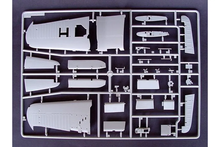 A grey plastic sprue containing various aircraft model parts, including wing sections and control surfaces, for a 1/32 scale model kit.