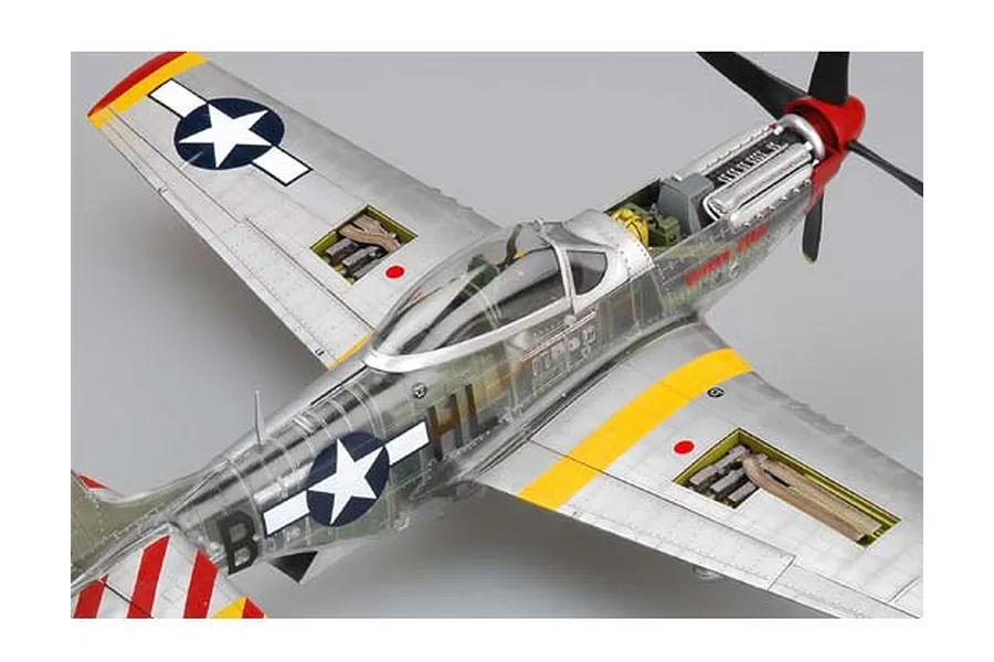 A high-angle view of a 1/32 scale P-51D Mustang model kit with a clear fuselage showing internal engine and cockpit details.