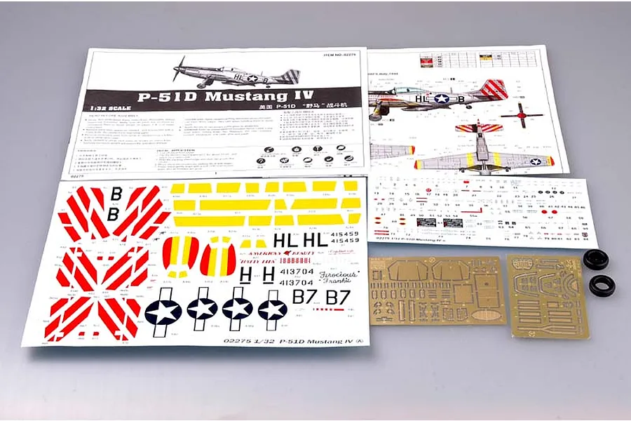 Trumpeter 1/32 P-51D Mustang IV model kit contents including instruction manual, decal sheets, photo-etched metal parts, and two small rubber tires.