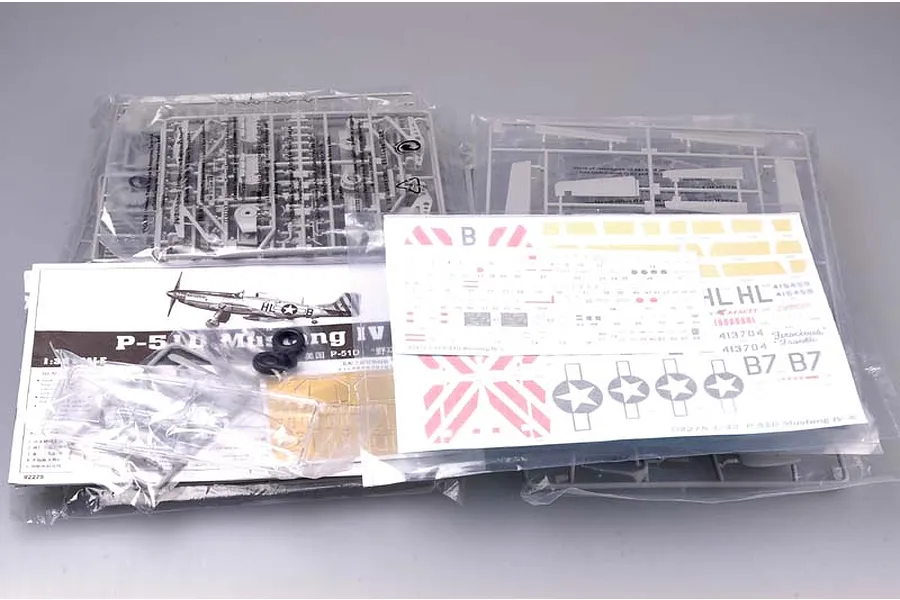 Trumpeter 1/32 scale P-51D Mustang IV model kit contents including plastic sprues, decal sheets, and instruction manual in clear plastic bags.