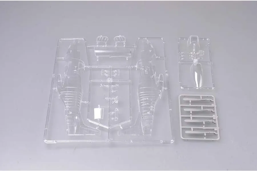 Clear plastic model kit sprues for a 1/32 scale P-51D Mustang, showing fuselage halves and canopy parts on a grey background.