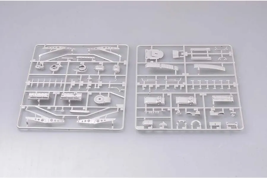 Two grey plastic model kit sprues containing various aircraft parts for a P-51D Mustang model, laid out on a plain light grey background.