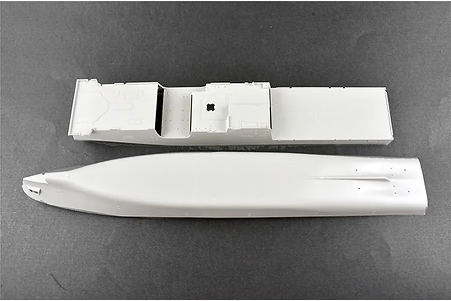 Two unpainted light grey plastic model ship hull parts for a 1/350 scale USS New York LPD-21 kit on a dark grey background.
