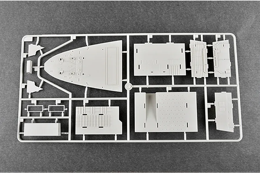 A grey plastic sprue containing various model ship parts for a 1/350 scale USS New York LPD-21 model kit, viewed from above against a dark grey background.