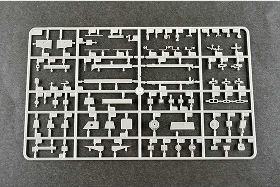 A grey plastic sprue containing various small parts for a 1/350 scale model kit, laid out on a dark textured surface.