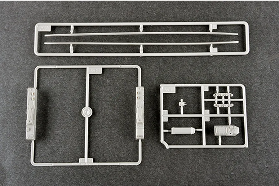 Three grey plastic model kit sprues from the Trumpeter 1/350 USS New York LPD-21 kit, laid out on a dark grey surface.