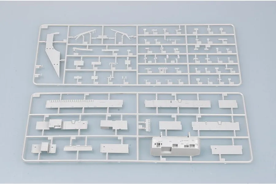 Two grey plastic model kit sprues containing various ship parts for the Trumpeter 1/700 USS Abraham Lincoln CVN-72 model kit.