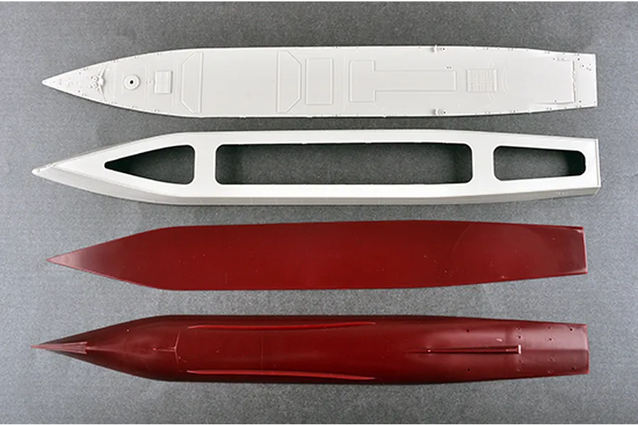 Top-down view of four unpainted plastic model ship hull components for a 1/350 scale JMSDF DDG-175 Myoko kit.