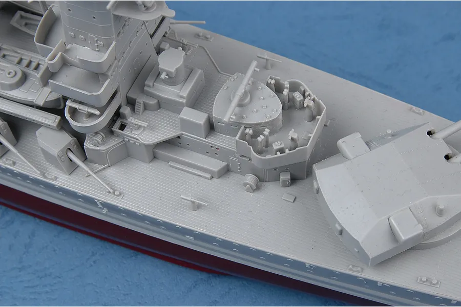 Close-up of a 1/350 scale plastic model battleship deck showing detailed superstructure, gun turrets, and anti-aircraft positions.