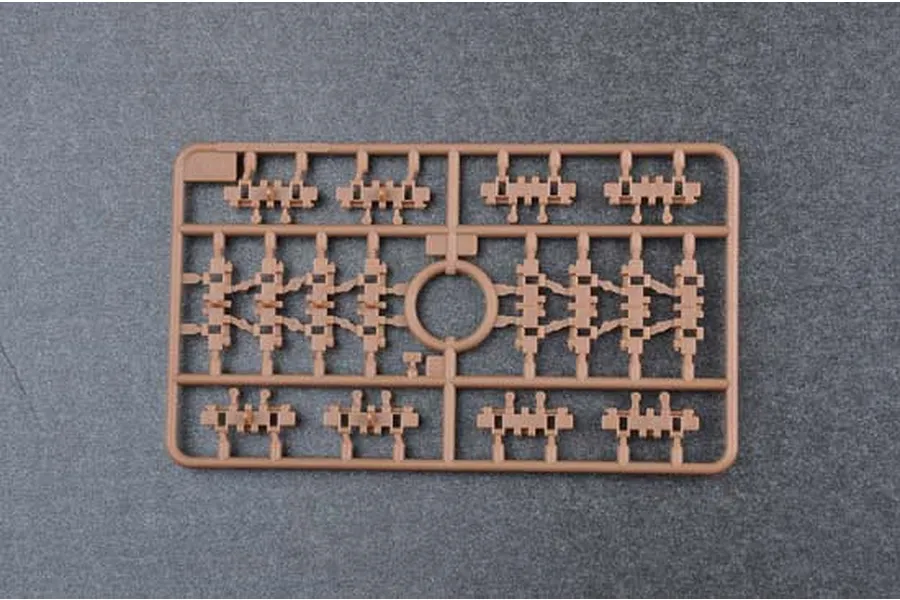 A brown plastic sprue containing small tank track link parts for a 1/35 scale model kit.
