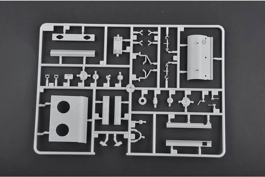 A grey plastic sprue from a 1/35 scale model kit containing various tank parts, including hull plates and small mechanical components.