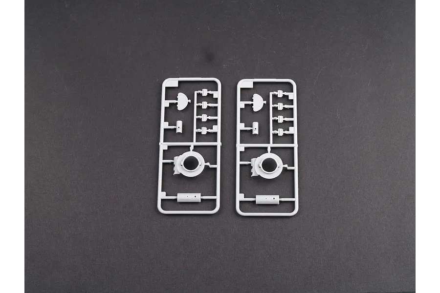 Two identical grey plastic model kit sprues containing small tank parts on a dark grey background.