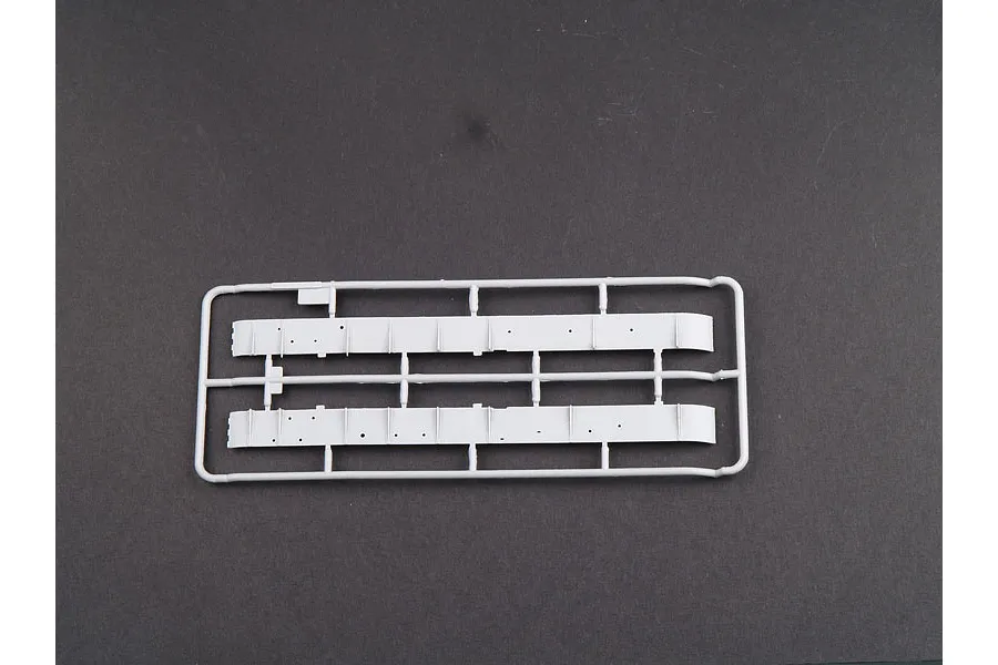 A grey plastic sprue containing two long tank hull side panels for a 1/35 scale model kit.