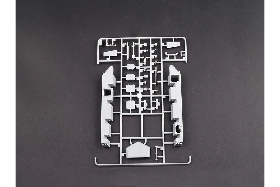 A grey plastic sprue containing various model tank parts for a 1/35 scale Trumpeter kit, laid out on a dark grey background.