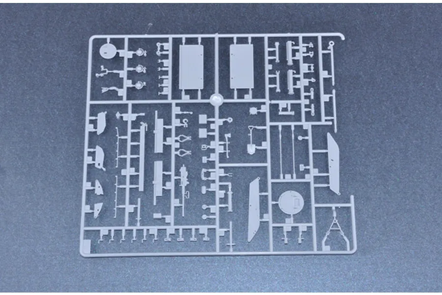 A grey plastic sprue containing various small model parts for a 1/35 scale military vehicle kit.