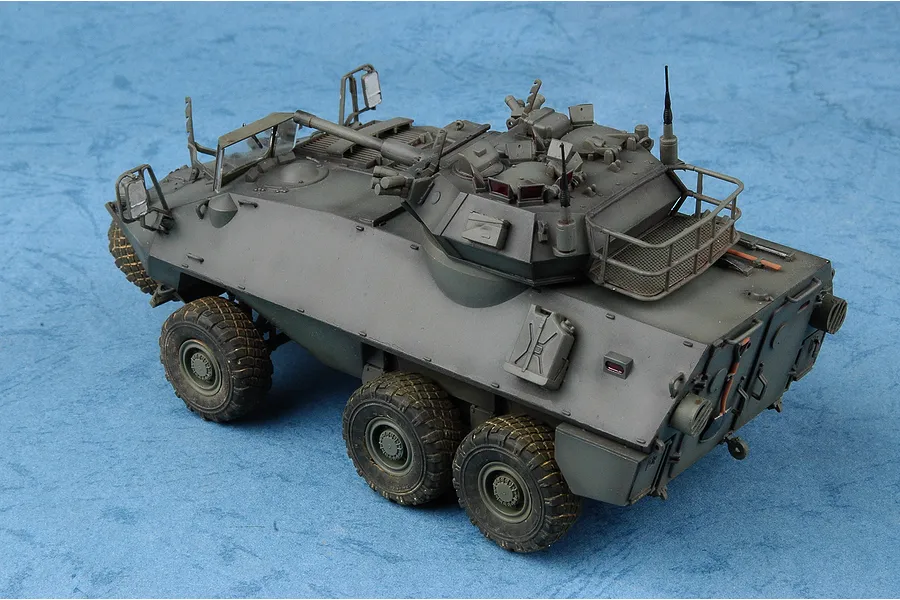 A 1/35 scale model of a Canadian Cougar AVGP armoured vehicle, painted in olive drab, shown from a high-angle rear three-quarter view.