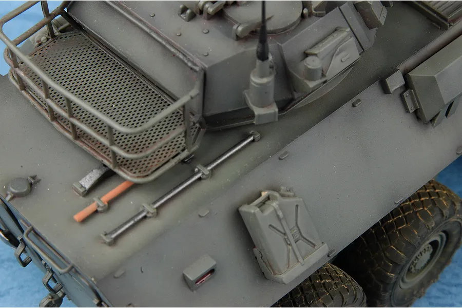 Close-up of a 1/35 scale model of a Canadian Cougar AVGP armoured vehicle showing the turret, storage rack, and jerry can detail.