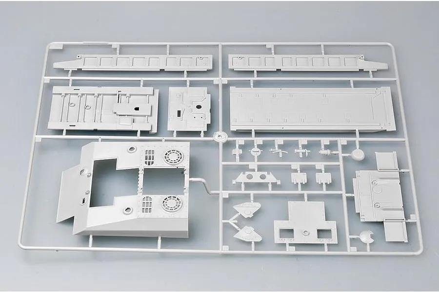 A grey plastic sprue containing various unpainted model kit parts for a 1/35 scale German military vehicle.
