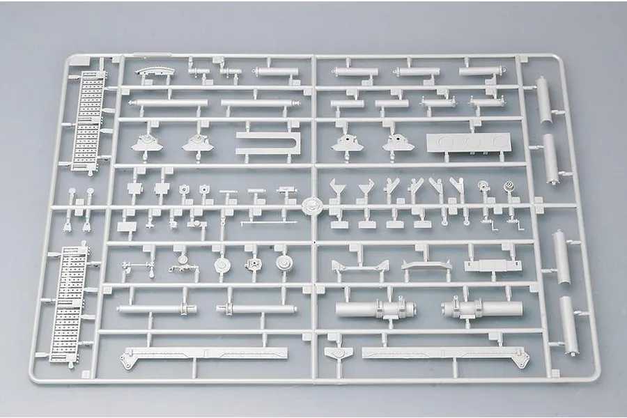 A grey plastic sprue containing various unattached model kit parts for a military vehicle, viewed from directly above against a plain background.