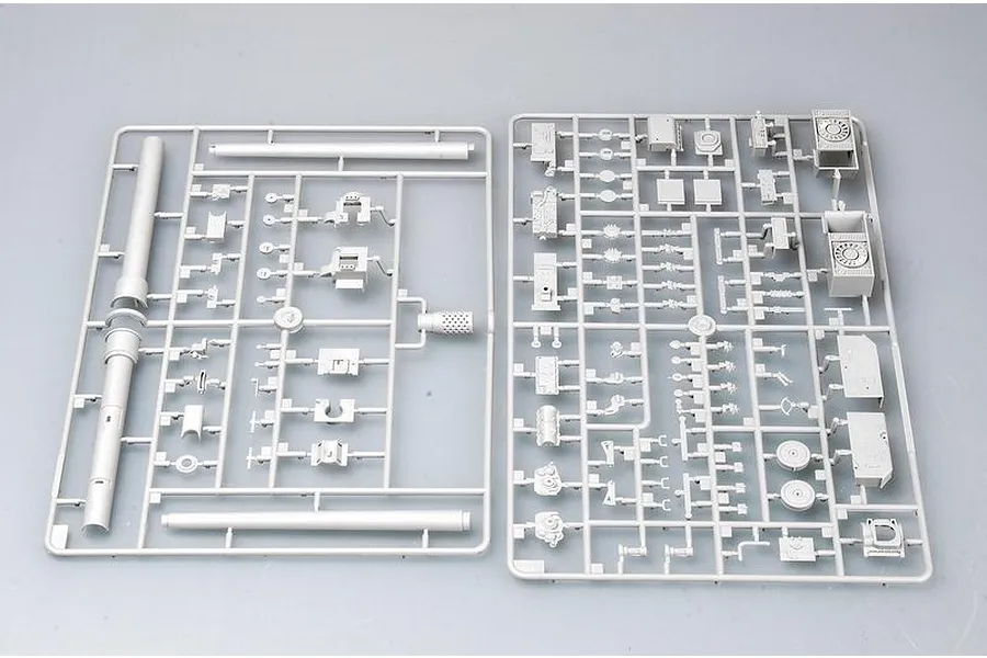 Two grey plastic model kit sprues containing various parts for a 1/35 scale military vehicle model, laid out on a plain light grey background.