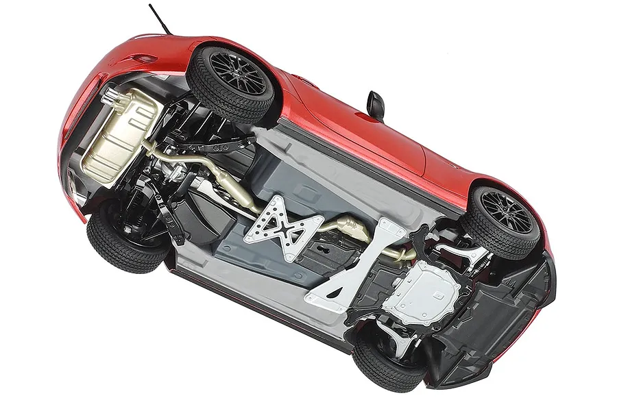 Underside view of a Tamiya 1/24 scale Mazda Roadster RF plastic model car showing detailed chassis, suspension, and exhaust components.