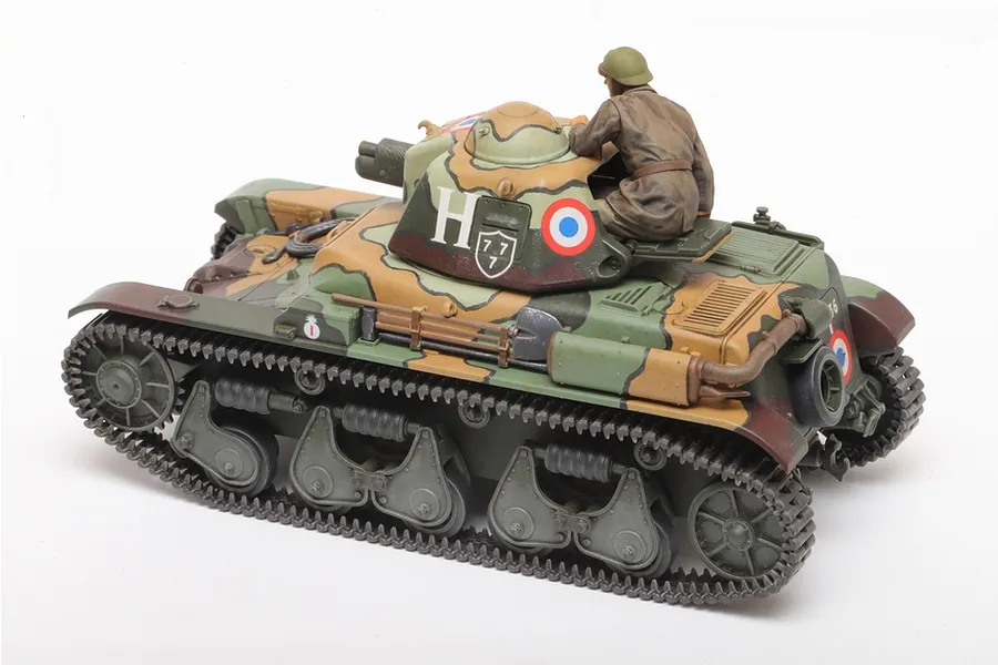 A 1/35 scale Tamiya French R35 tank model kit, fully assembled and painted in a camouflage pattern with a tank commander figure in the turret.
