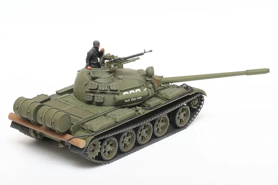 A 1/48 scale Tamiya T-55 Russian tank model kit, fully assembled and painted in olive green with a tank commander figure in the turret.