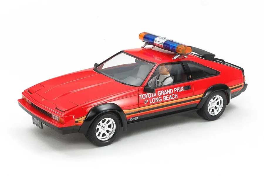 A 1/24 scale Tamiya model of a red Toyota Celica Supra Long Beach Grand Prix marshal car with a roof-mounted light bar and driver figure.