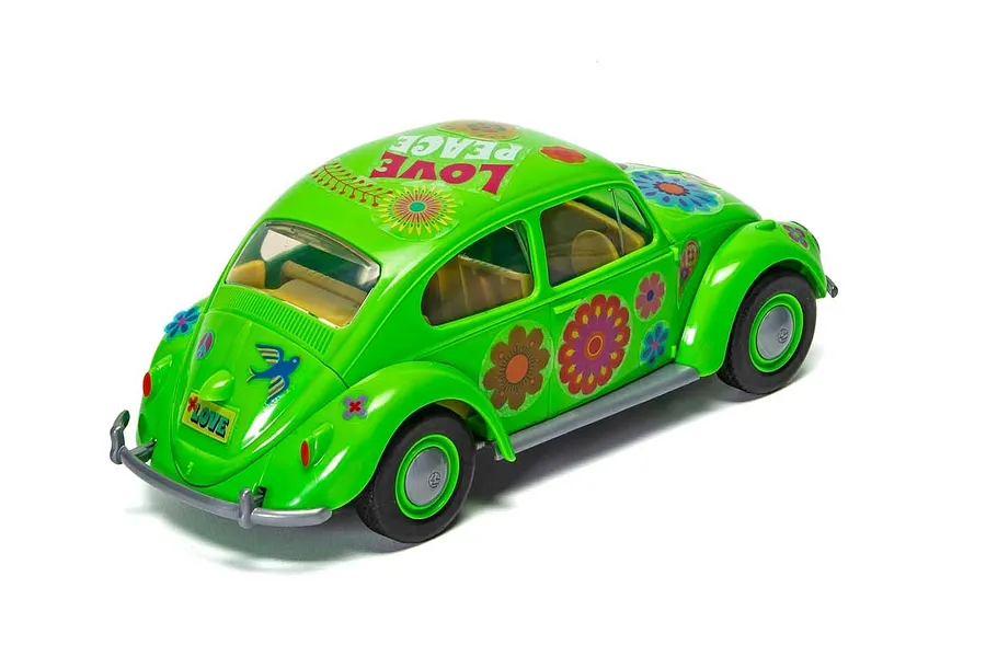 A bright green Airfix Quickbuild Volkswagen Beetle model car with flower power decals and a Love Peace sticker on the roof, viewed from the rear three-quarter angle.