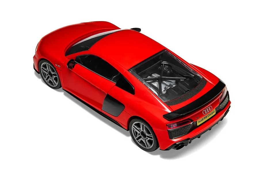 A high-angle studio shot of a red Audi R8 Coupe model car, showing the rear engine bay, spoiler, and V10 branding.