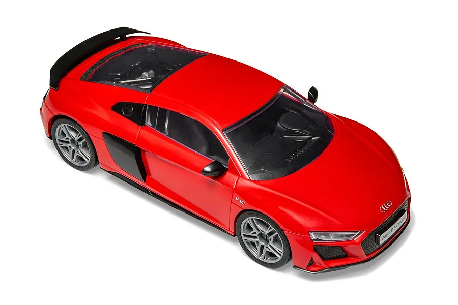 High-angle view of a red Airfix Quickbuild Audi R8 Coupe model car on a white background.