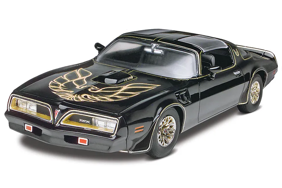 A 1/25 scale model of a black 1977 Pontiac Firebird from Smokey and the Bandit, featuring the iconic gold hood bird decal and gold snowflake wheels.