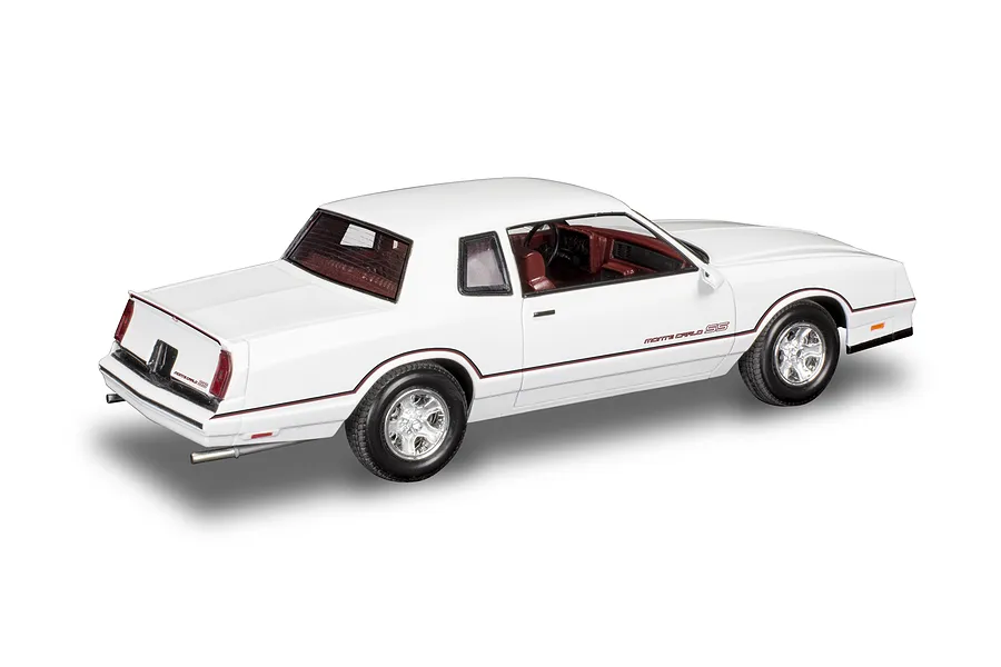 A completed 1/24 scale plastic model of a white 1986 Chevrolet Monte Carlo SS, viewed from the rear three-quarter angle.