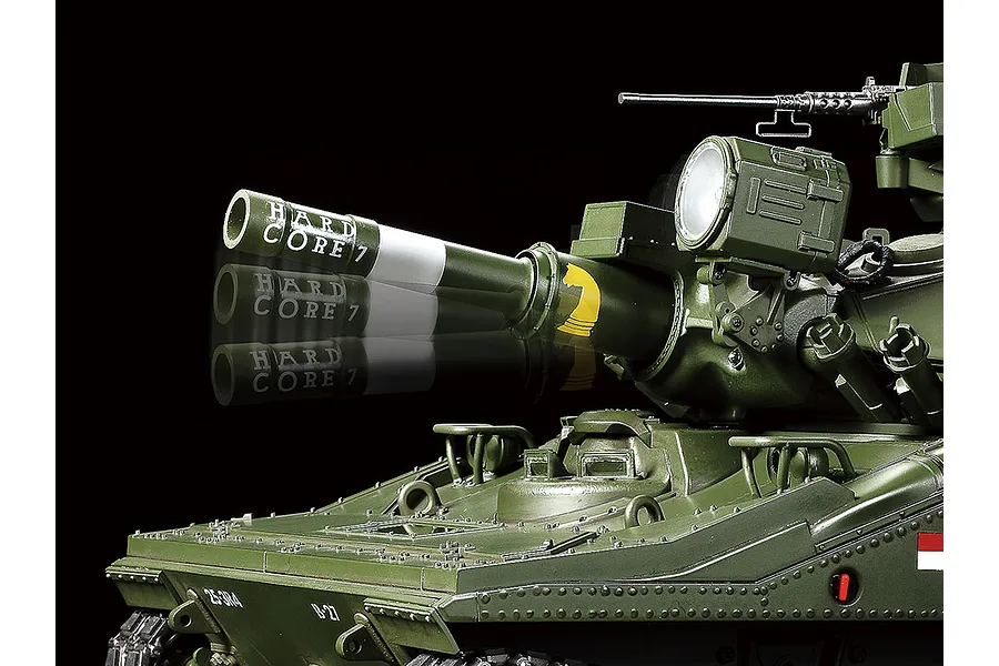 Close-up of the turret and main gun of a Tamiya 1/16 scale M551 Sheridan RC tank, showing a motion blur effect on the barrel.