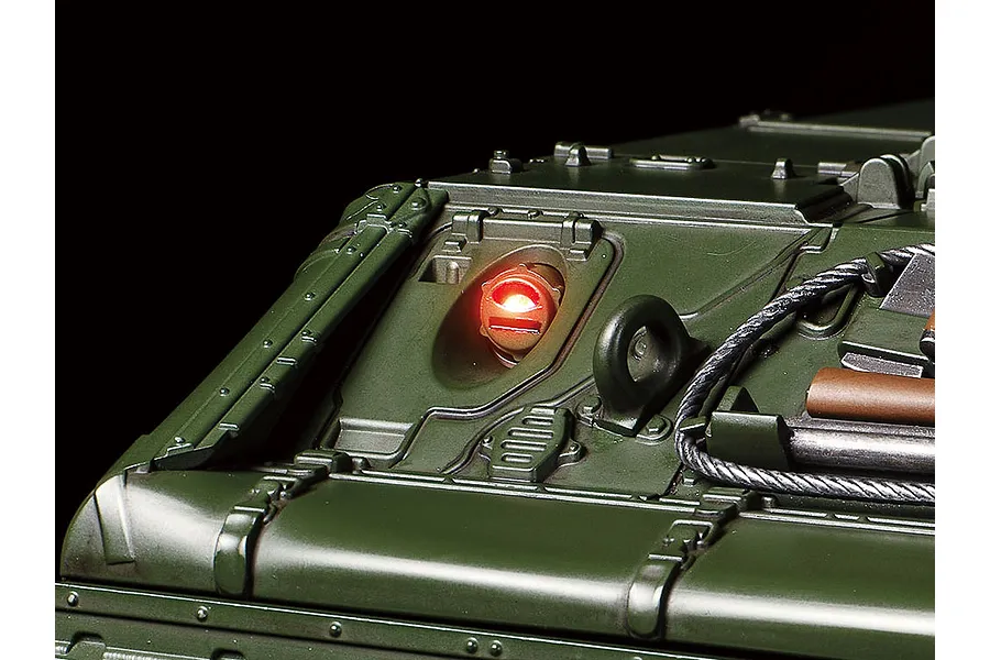 Close-up of the green hull of a Tamiya 1/16 M551 Sheridan RC tank showing a glowing red light feature.