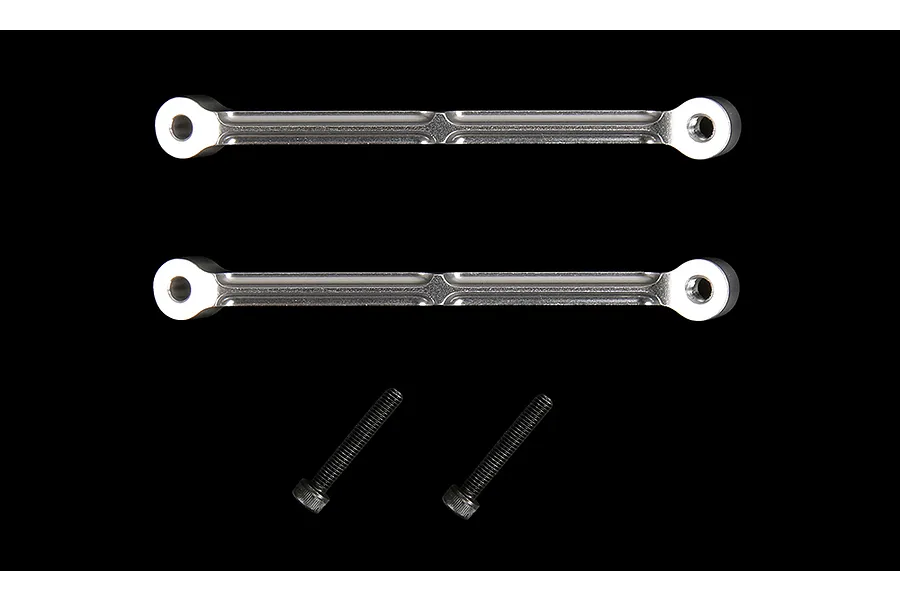 Two silver aluminium RC shock tower braces and two black metal screws against a black background.