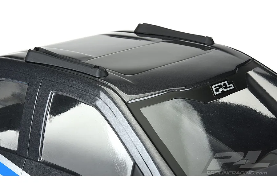 Close-up of a black RC car body roof featuring two black plastic skid plates installed on the roof rails against a white background.