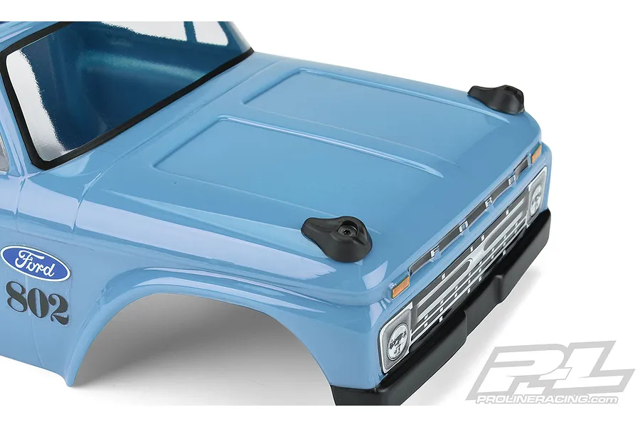 Close-up of a blue RC truck body shell showing two black plastic skid plates mounted on the hood.