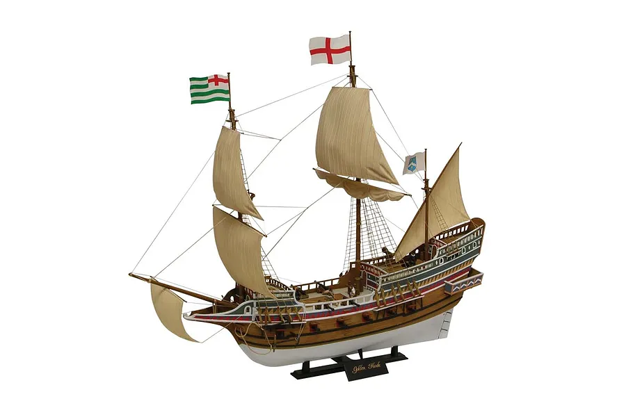 A fully assembled and painted plastic model of the historic Golden Hind ship, featuring detailed rigging, sails, and flags on a black display stand.