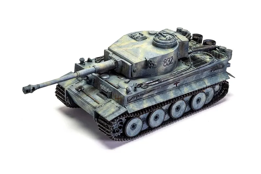 A high-angle studio shot of a fully assembled and painted 1/35 scale Tiger 1 tank model with a weathered grey and tan camouflage finish.
