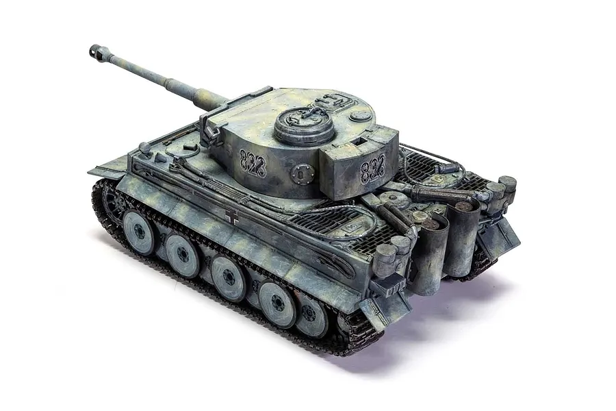 A high-angle view of a painted and weathered 1/35 scale Tiger 1 tank model, featuring a winter camouflage scheme and the number 823 on the turret.