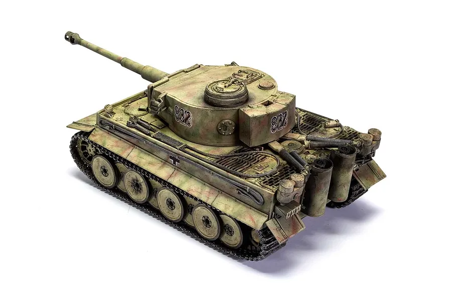 A high-angle studio shot of a fully assembled and painted 1/35 scale Tiger I tank model, featuring camouflage paint and the number 823 on the turret.