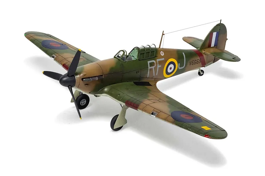A fully assembled and painted 1/48 scale model of a Hawker Hurricane Mk.1 fighter plane, featuring camouflage paint and RAF markings.